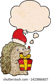 cartoon hedgehog wearing christmas hat with thought bubble in grunge texture style