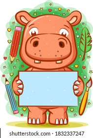 The cartoon of the hippopotamus holding the blank paper around the writing tools