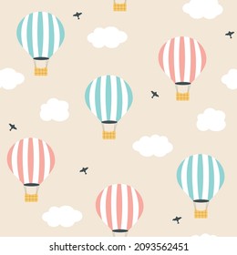 Cartoon hot air balloon in the sky seamless pattern. Cute flying balloons and clouds kids background. Hand drawn vector illustration for baby.