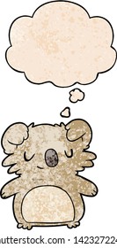 cartoon koala with thought bubble in grunge texture style