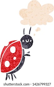 cartoon ladybug with thought bubble in grunge distressed retro textured style