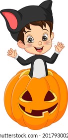 Cartoon little boy wearing halloween cat costume inside pumpkin