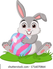 Cartoon little rabbit holding easter egg in the grass