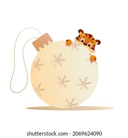 A cartoon little tiger and Christmas tree toy. Year of the Chinese Tiger. Christmas ball isolated on white background