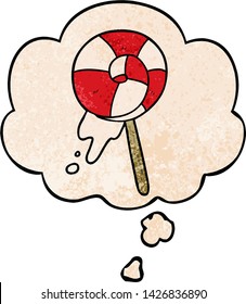 cartoon lollipop with thought bubble in grunge texture style