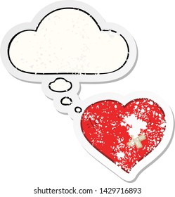 cartoon love heart with sticking plaster with thought bubble as a distressed worn sticker