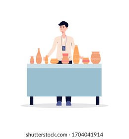 Cartoon man at pottery exhibition standing behind table selling ceramic clay vases and pots. Isolated male seller with handmade crockery - flat vector illustration.