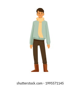 Cartoon man in warm clothes - young person wearing sweater and scarf standing isolated on white background and smiling. Vector illustration of guy in autumn outfit.