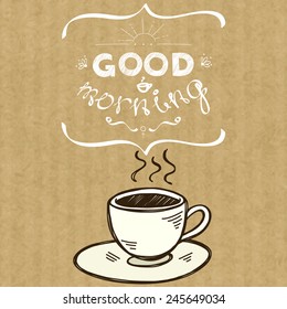 Cartoon morning cup of coffee. Hand drawn doodle cup and hand written lettering Good Morning, isolated on brown kraft paper background.