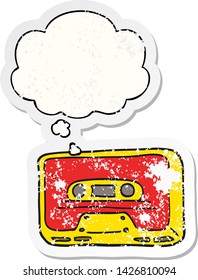 cartoon old tape cassette with thought bubble as a distressed worn sticker