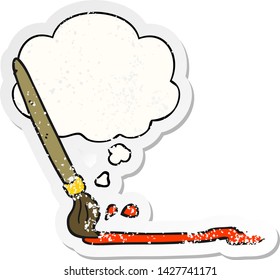 cartoon paintbrush with thought bubble as a distressed worn sticker
