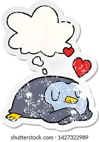 cartoon penguin in love with thought bubble as a distressed worn sticker