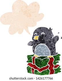 cartoon penguin on present with speech bubble in grunge distressed retro textured style