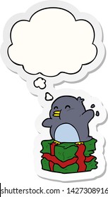 cartoon penguin on present with thought bubble as a printed sticker