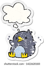 cartoon penguin with thought bubble as a distressed worn sticker