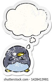 cartoon penguin with thought bubble as a distressed worn sticker
