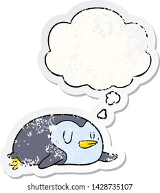 cartoon penguin with thought bubble as a distressed worn sticker