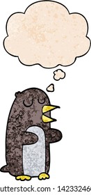 cartoon penguin with thought bubble in grunge texture style