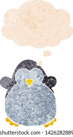 cartoon penguin with thought bubble in grunge distressed retro textured style