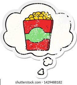 cartoon popcorn with thought bubble as a distressed worn sticker