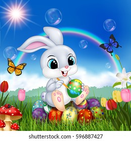 Cartoon rabbit decorating an Easter egg