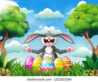 Cartoon rabbit laughing with five decorated easter eggs in the park