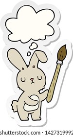 cartoon rabbit with paint brush with thought bubble as a printed sticker