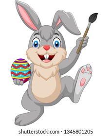 Cartoon rabbit painting an Easter egg