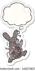 cartoon rabbit with thought bubble as a distressed worn sticker