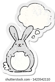 cartoon rabbit with thought bubble as a distressed worn sticker