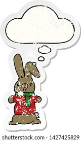 cartoon rabbit with thought bubble as a distressed worn sticker