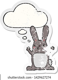 cartoon rabbit with thought bubble as a distressed worn sticker