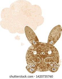 cartoon rabbit with thought bubble in grunge distressed retro textured style