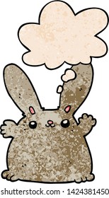 cartoon rabbit with thought bubble in grunge texture style
