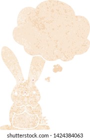 cartoon rabbit with thought bubble in grunge distressed retro textured style