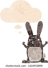 cartoon rabbit with thought bubble in grunge distressed retro textured style