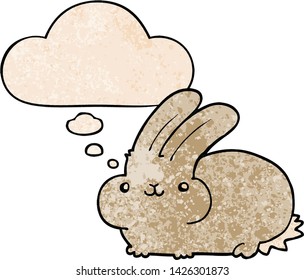 cartoon rabbit with thought bubble in grunge texture style