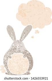 cartoon rabbit with thought bubble in grunge distressed retro textured style