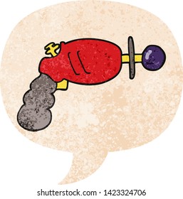 cartoon ray gun with speech bubble in grunge distressed retro textured style
