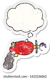 cartoon ray gun with thought bubble as a distressed worn sticker