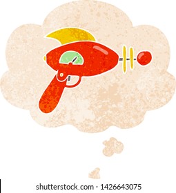 cartoon ray gun with thought bubble in grunge distressed retro textured style