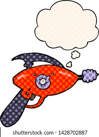 cartoon ray gun with thought bubble in comic book style