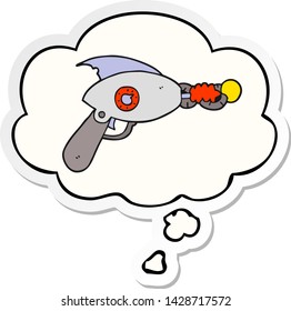 Cartoon-Ray-Gewehr mit Denkblase als Druckaufkleber