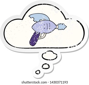 cartoon ray gun with thought bubble as a distressed worn sticker