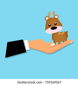 cartoon reindeer or deer sitting on a hand. Deer toy or character