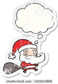 cartoon santa claus with sack with thought bubble as a distressed worn sticker
