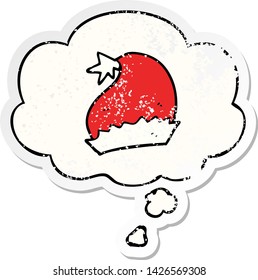 cartoon santa hat with thought bubble as a distressed worn sticker