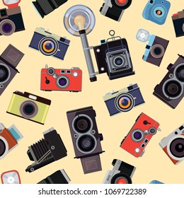 Cartoon seamless pattern with illustrations of retro photo cameras