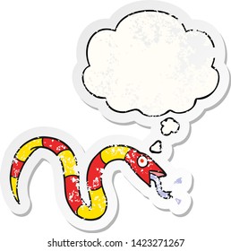 cartoon snake with thought bubble as a distressed worn sticker