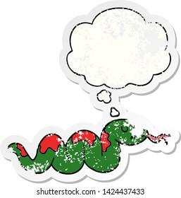 cartoon snake with thought bubble as a distressed worn sticker